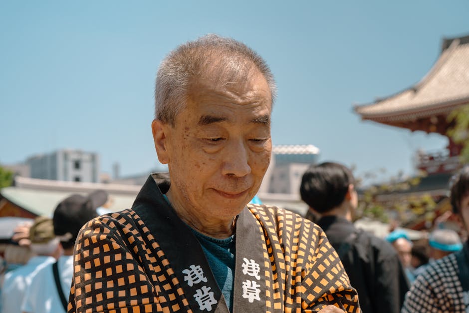 Elderly man in traditional Japanese attire at a festival in Tokyo, Japan. Vibrant and cultural scene.