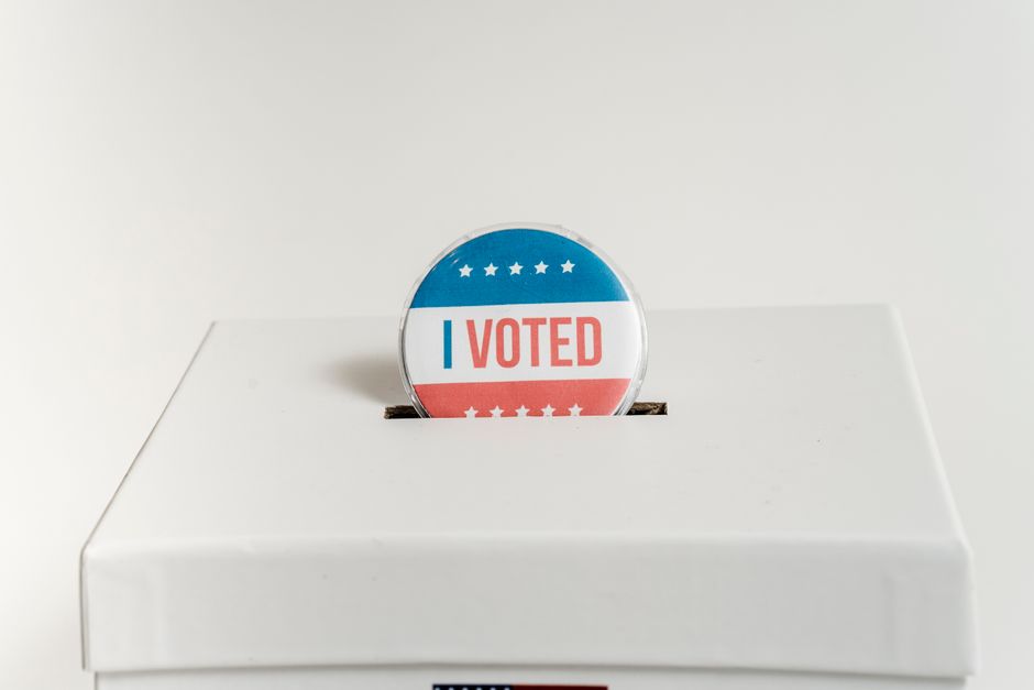 Close-up of an I Voted badge on a ballot box, symbolizing voting in the USA elections.