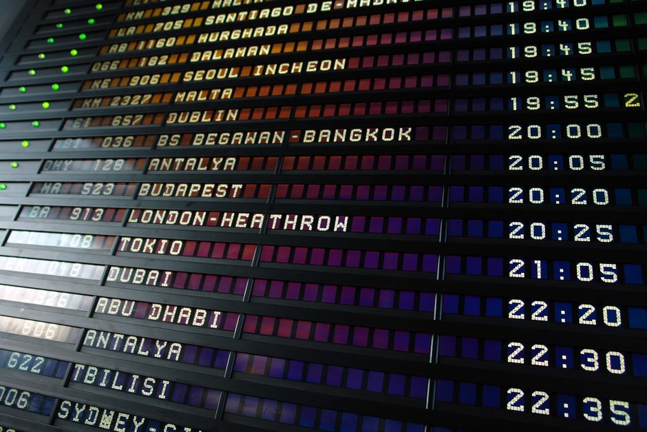 Departures board inside a European airport terminal listing international flights