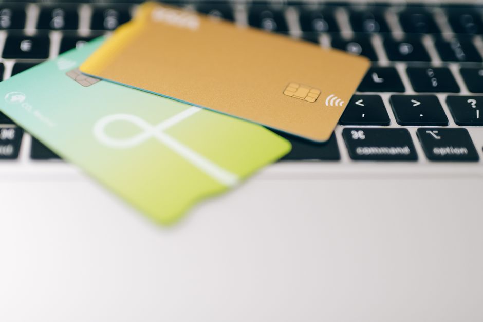 Two credit cards placed side by side on a plain white surface