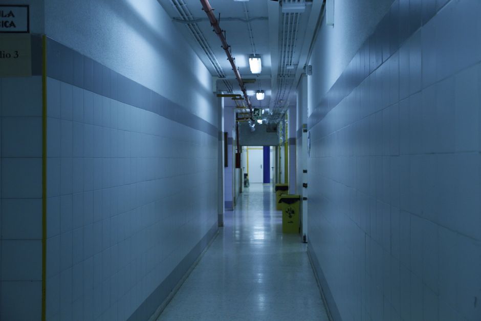 An empty corridor in a hospital research building with closed doors