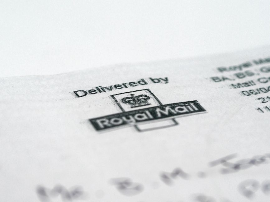 Certified mail envelope with green return receipt card on a table