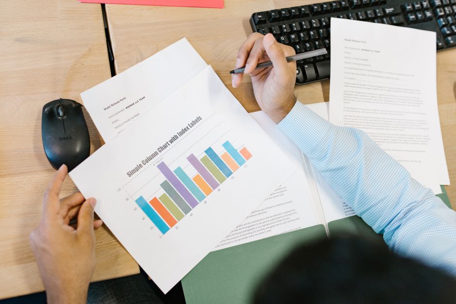 An office worker comparing rows of figures on a computer spreadsheet
