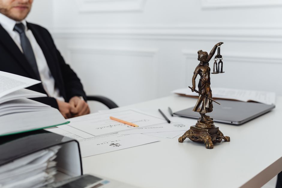 Legal documents and a pen on a table inside a courthouse office