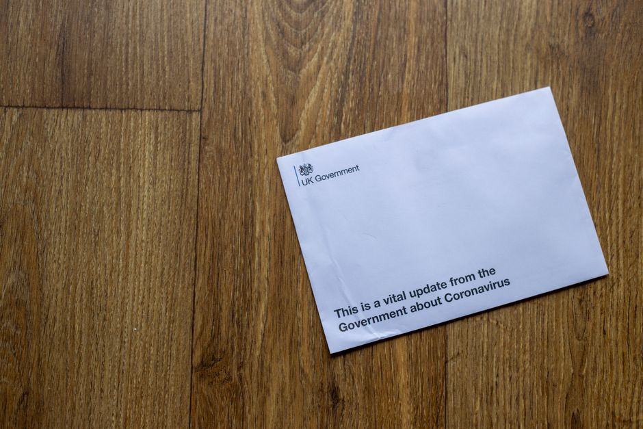 An official government envelope and letter opened on a kitchen table