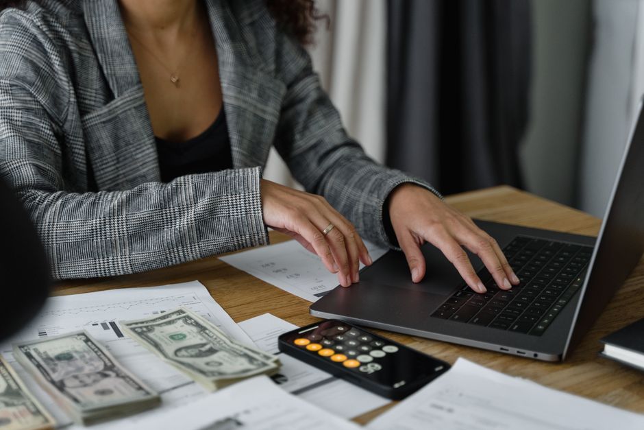 A person checking a retirement account balance on a laptop at home