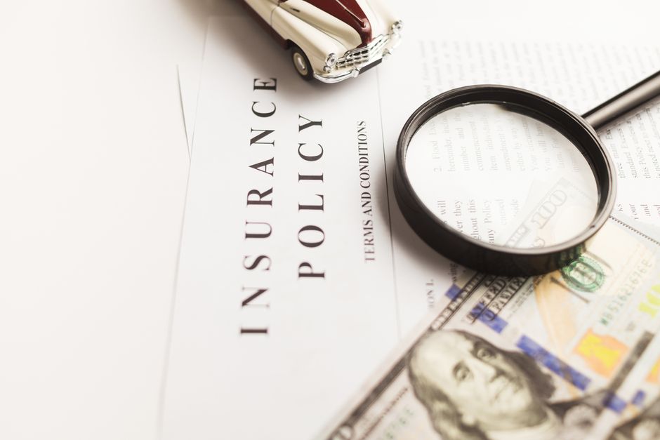 Close-up of an insurance policy document being read at a kitchen table