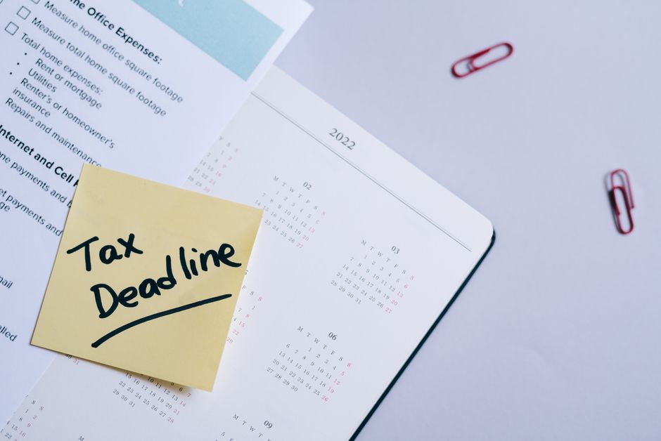 A wall calendar with a date circled in red marker beside a stack of mail