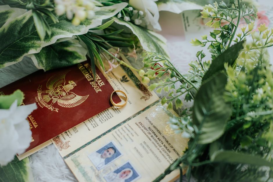 A marriage certificate and family photographs laid out on a table