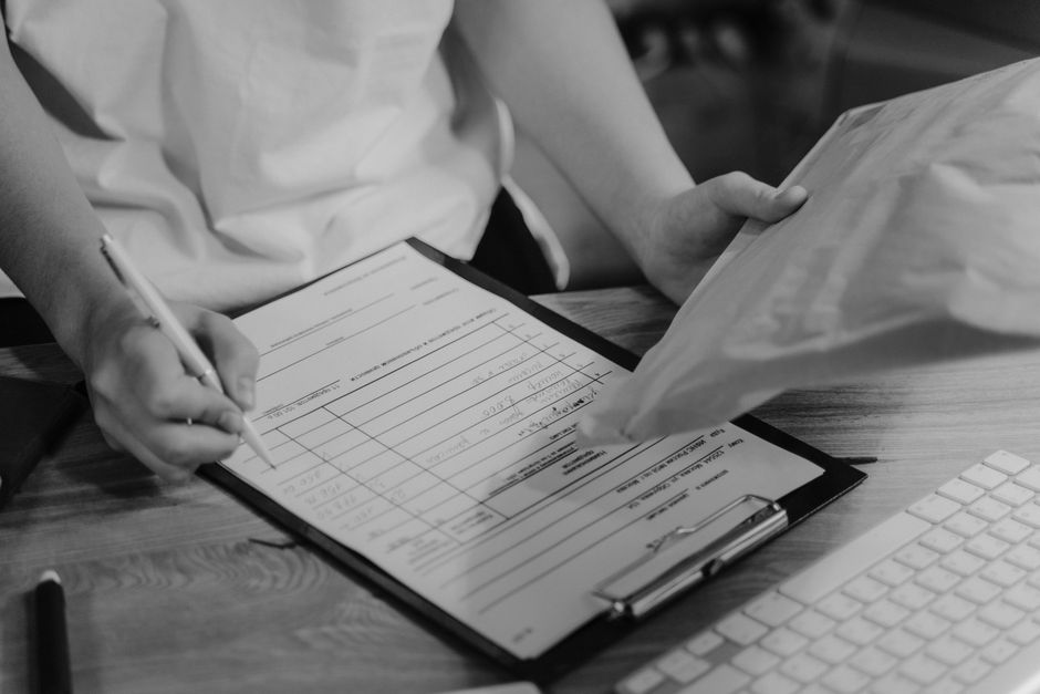 Printed immigration application forms and a large envelope on a desk