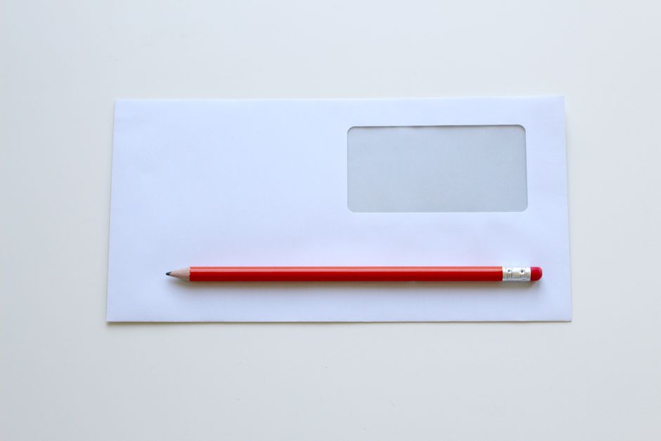 A formal printed letter and opened envelope on a table